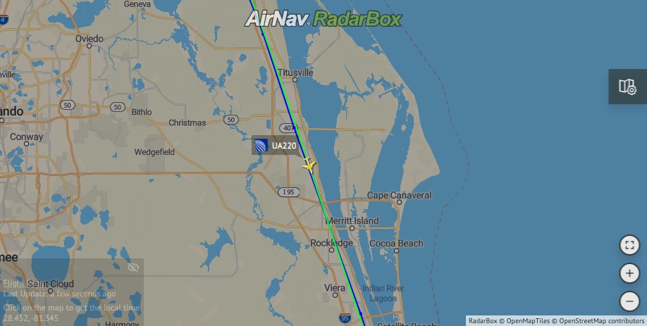 United Airline's flight over Cape Canaveral as a SpaceX rocket is launched.